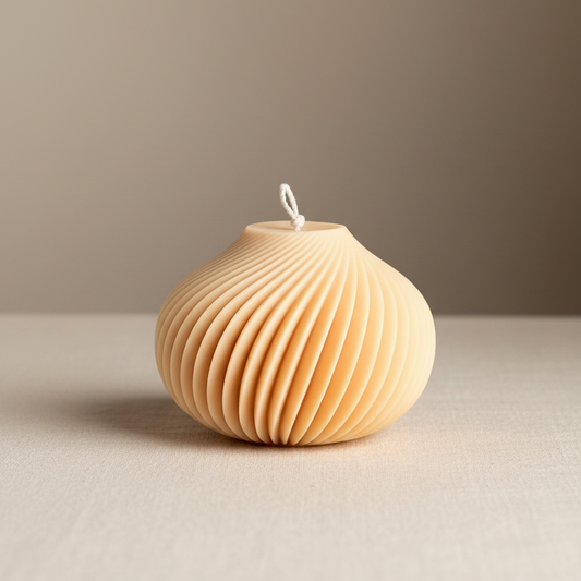 Warm sand cream round spiral ridge sculptural soy candle with diagonal swirl texture — Estelle Studio artisan statement candle, modern home décor Canada