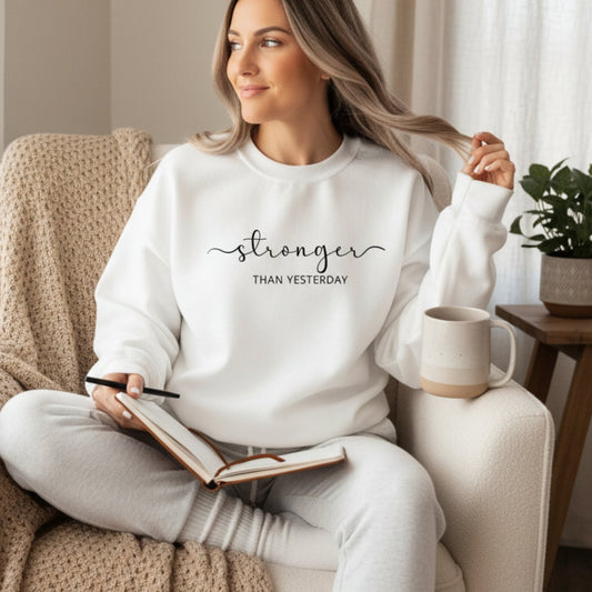 Women's Stronger Than Yesterday crewneck sweatshirt — motivational fitness and personal growth gift for women