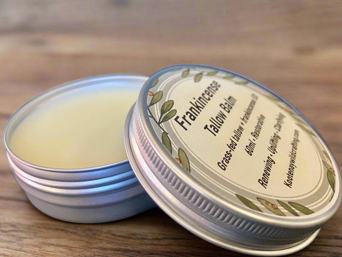 Frankincense Tallow balm in a metal tin with a label on a wooden surface