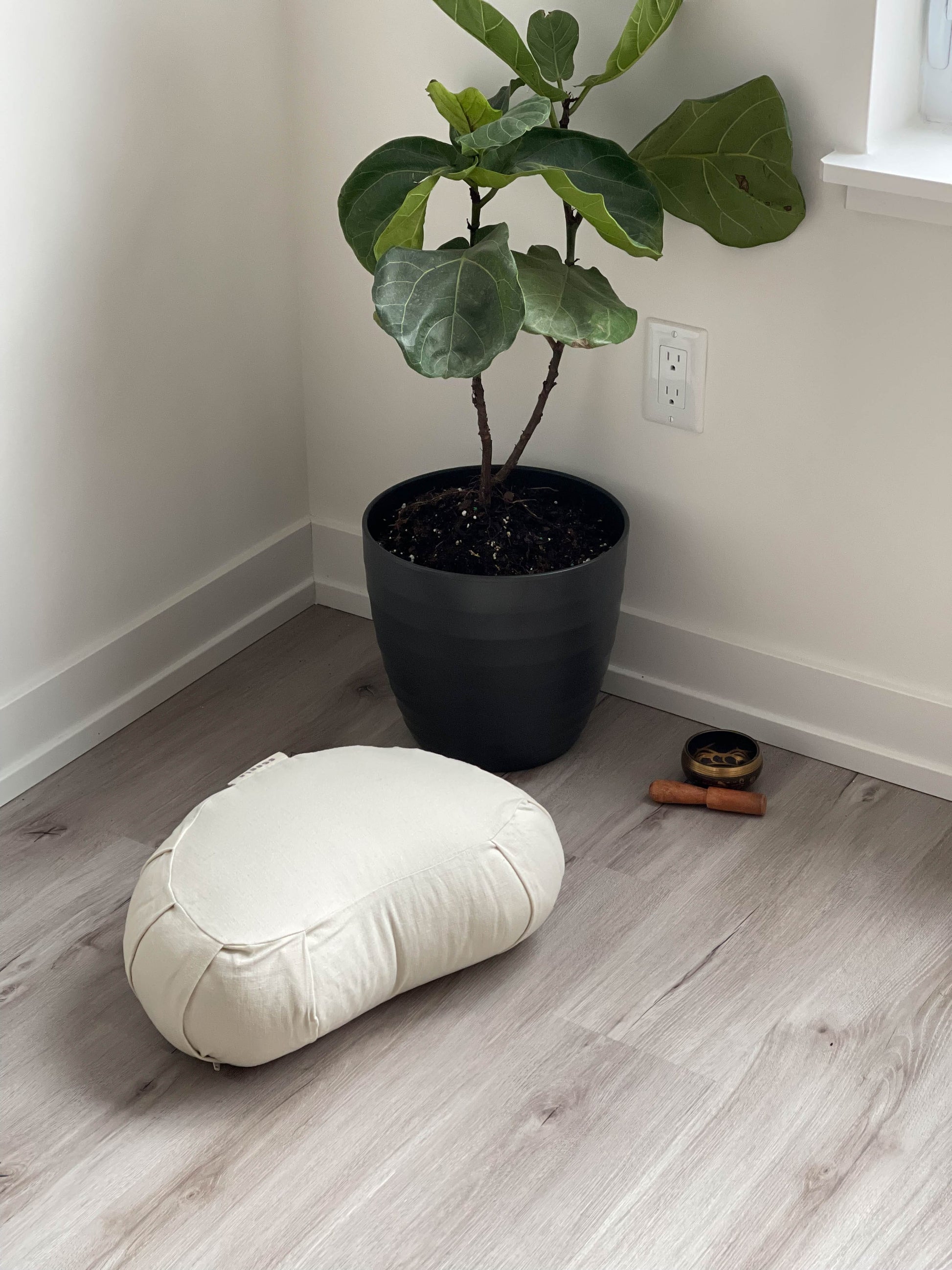 beige meditation cushion on the floor