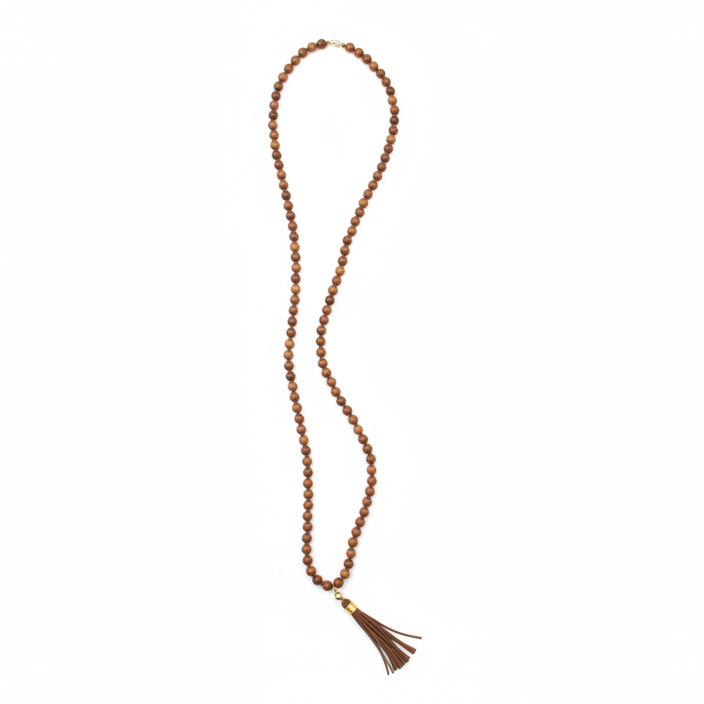 Handcrafted wooden mala necklace draped on white background — natural wood beads handmade in India for meditation, yoga, and spiritual practice